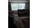 Living room with a large window and two couches and a floral rug at 9516 Glen Moor Ln, Port Richey, FL 34668