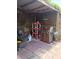 Covered backyard patio features a barbecue grill, propane tank and a shelf unit at 9516 Glen Moor Ln, Port Richey, FL 34668