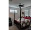 Cozy bedroom featuring a four-poster bed and a ceiling fan at 9967 Patrician Dr, New Port Richey, FL 34655