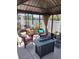 Outdoor gazebo with seating and a table creates a cozy atmosphere in the backyard at 9967 Patrician Dr, New Port Richey, FL 34655