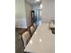 Elegant kitchen island with quartz countertop, seating, and contemporary pendant lighting fixtures at 9967 Patrician Dr, New Port Richey, FL 34655
