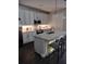 Modern kitchen with stainless steel appliances, a stylish island with seating, and ample cabinet space at 9967 Patrician Dr, New Port Richey, FL 34655