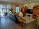 Spacious living room featuring wood floors, a ceiling fan, and a sliding glass door to the patio at 9967 Patrician Dr, New Port Richey, FL 34655
