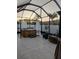 Enclosed patio with a hot tub and string lights at sunset at 9967 Patrician Dr, New Port Richey, FL 34655