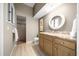 Bathroom featuring a granite countertop, wood cabinets and walk-in shower at 10044 Twelve Oaks Ct, Weeki Wachee, FL 34613