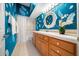 Bathroom with blue walls, white trim, and a decorative white mirror and vanity at 10044 Twelve Oaks Ct, Weeki Wachee, FL 34613