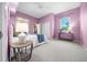 This bedroom features lavender walls, white trim and carpeted floors at 10044 Twelve Oaks Ct, Weeki Wachee, FL 34613