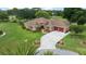 Beautiful home with manicured lawn, lush landscaping and concrete driveway leading to a spacious two-car garage at 10044 Twelve Oaks Ct, Weeki Wachee, FL 34613