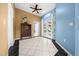 Entryway with white tile floor, blue accent wall, and a view to the pool area at 10044 Twelve Oaks Ct, Weeki Wachee, FL 34613