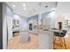 Bright kitchen with stainless steel appliances, center island, and tiled flooring at 10044 Twelve Oaks Ct, Weeki Wachee, FL 34613