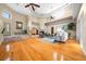 Spacious living room with hardwood floors, high ceilings, a fireplace, and large windows overlooking the yard at 10044 Twelve Oaks Ct, Weeki Wachee, FL 34613