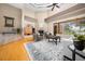Living room featuring hardwood floors, high ceilings, a fireplace, comfortable seating, and large windows at 10044 Twelve Oaks Ct, Weeki Wachee, FL 34613