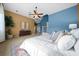 Spacious main bedroom with blue and tan accent walls, fan, and a decorative area rug at 10044 Twelve Oaks Ct, Weeki Wachee, FL 34613