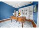 Stylish office with a blue accent wall, built-in shelving, hardwood floors, and an ornate desk at 10044 Twelve Oaks Ct, Weeki Wachee, FL 34613