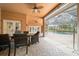 Covered patio features a dining table and leads to screened-in pool at 10044 Twelve Oaks Ct, Weeki Wachee, FL 34613