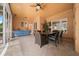 Back patio featuring brick floors, a table and chairs, and access to the yard and pool at 10044 Twelve Oaks Ct, Weeki Wachee, FL 34613