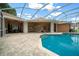 A tranquil swimming pool is steps from the patio at 10044 Twelve Oaks Ct, Weeki Wachee, FL 34613