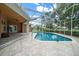 The screened-in pool overlooks the lush backyard at 10044 Twelve Oaks Ct, Weeki Wachee, FL 34613