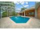 Backyard screened-in pool with brick pavers at 10044 Twelve Oaks Ct, Weeki Wachee, FL 34613