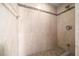 Walk-in shower with tile walls, mosaic accent tiles, and bronze showerhead at 10044 Twelve Oaks Ct, Weeki Wachee, FL 34613