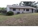 Backyard with solar panels, showing a well-maintained lawn, and windows offering lots of natural light at 101 Sheryl Lynn Dr, Brandon, FL 33510