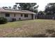 Exterior of the home with solar panels highlighting a well-kept lawn, and fenced perimeter at 101 Sheryl Lynn Dr, Brandon, FL 33510