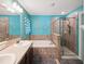 This modern bathroom features a separate tub, a shower, and dual sinks at 10120 Ives Loop, Hudson, FL 34667