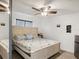 Cozy bedroom with a queen-sized bed, ceiling fan, and laminate flooring at 10120 Ives Loop, Hudson, FL 34667