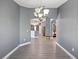 Open concept dining room showcasing stylish lighting and connecting to the kitchen and living areas at 10120 Ives Loop, Hudson, FL 34667