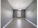 Empty dining room with laminate wood floors, natural light, and a modern chandelier at 10120 Ives Loop, Hudson, FL 34667