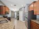 Well-equipped kitchen featuring stainless steel appliances, granite countertops, and wood cabinets at 10120 Ives Loop, Hudson, FL 34667