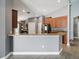 Open kitchen featuring granite countertops, stainless steel appliances, and wood cabinets, perfect for entertaining at 10120 Ives Loop, Hudson, FL 34667