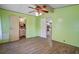 Bright bedroom offers wood flooring and easy access to a bathroom and kitchen at 10149 Huntley St, New Port Richey, FL 34654