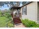 Close-up of the front porch steps entrance, surrounded by lush landscaping at 10149 Huntley St, New Port Richey, FL 34654