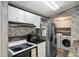 Bright kitchen featuring stainless steel appliances, white cabinets, and a wooden backsplash at 10149 Huntley St, New Port Richey, FL 34654