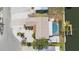 An aerial view shows the home's layout, landscaping, pool, and proximity to the water and boat dock at 1024 Spindle Palm Way, Apollo Beach, FL 33572