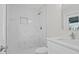 Bright bathroom showcasing a glass-enclosed shower with white marble tiling, a modern vanity, and a stylish faucet at 1024 Spindle Palm Way, Apollo Beach, FL 33572