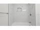 Modern bathroom featuring elegant white tile, a sleek shower, and a built-in niche at 1024 Spindle Palm Way, Apollo Beach, FL 33572