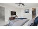 Sleek bedroom featuring neutral tones, a flat-screen television, and modern furnishings at 1024 Spindle Palm Way, Apollo Beach, FL 33572