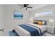 Inviting bedroom with stylish decor, a comfortable bed, and a ceiling fan at 1024 Spindle Palm Way, Apollo Beach, FL 33572