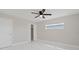 Bedroom with white marble floors, window with blinds, ceiling fan, and walk-in closet at 1024 Spindle Palm Way, Apollo Beach, FL 33572
