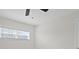 Bright bedroom with neutral walls, modern ceiling fan, and a window that allows for natural light at 1024 Spindle Palm Way, Apollo Beach, FL 33572