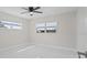 Spacious bedroom with two windows providing natural light and stylish, easy-to-clean tile flooring at 1024 Spindle Palm Way, Apollo Beach, FL 33572