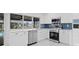 Well-equipped kitchen with stainless steel appliances and blue tiled backsplash provides stylish food prep at 1024 Spindle Palm Way, Apollo Beach, FL 33572