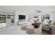 Spacious living room with modern furnishings, sleek flooring, and ample natural light at 1024 Spindle Palm Way, Apollo Beach, FL 33572