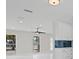 This bright living room boasts modern recessed lights, a ceiling fan, and windows for plenty of sunlight at 1024 Spindle Palm Way, Apollo Beach, FL 33572