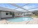 Inviting in-ground pool surrounded by a tiled patio and a screened enclosure at 1024 Spindle Palm Way, Apollo Beach, FL 33572