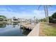 Scenic waterfront featuring a canal with boat docks and lush landscaping at 1024 Spindle Palm Way, Apollo Beach, FL 33572