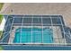 Aerial view of private screened-in pool with beautiful blue water at 10250 Locker Dr, Spring Hill, FL 34608