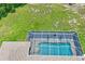 Aerial view showcases the pool and verdant lawn surrounding the property at 10250 Locker Dr, Spring Hill, FL 34608